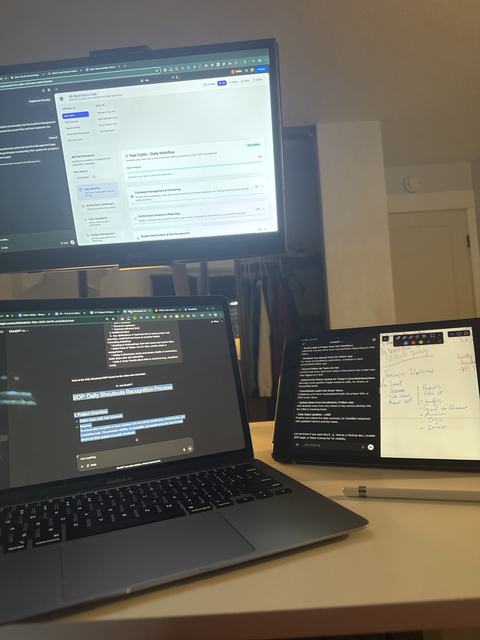 A desk with a monitor, a laptop and a tablet, each open to a different working document